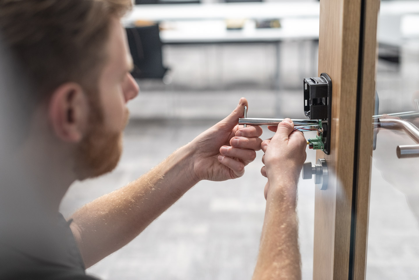 Engineer installing a smart access control lock